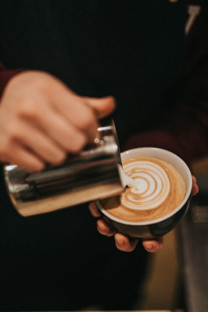 Pouring latte into a mug